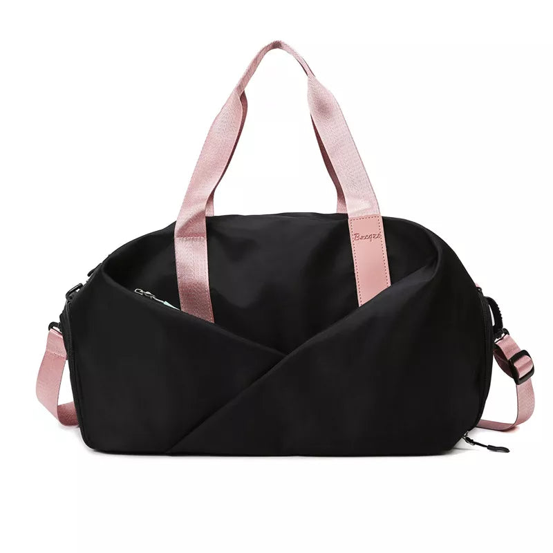 Black nylon travel bag with pink straps and adjustable shoulder strap.