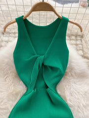 Emerald green ribbed knit midi dress with knot-back detail and cutout.