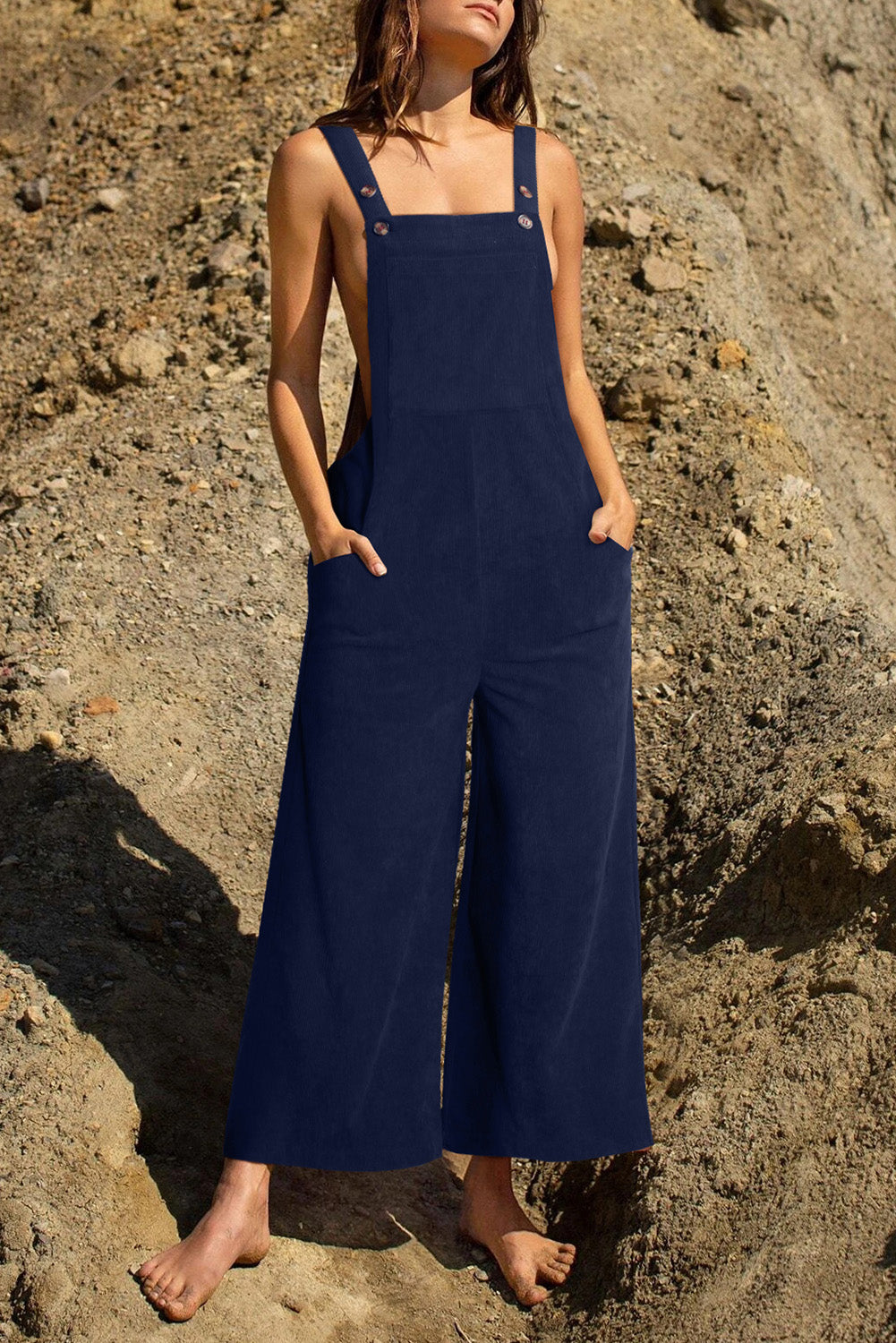 Dark Blue corduroy overalls with wide legs and buttoned straps, featuring side pockets.