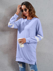 Blue purple sweatshirt dress with varsity stripe detail on sleeves, crew neck, long sleeves, and side slits.