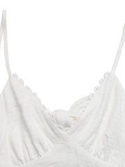 White lace tiered maxi dress with scalloped trim and a knot detail.