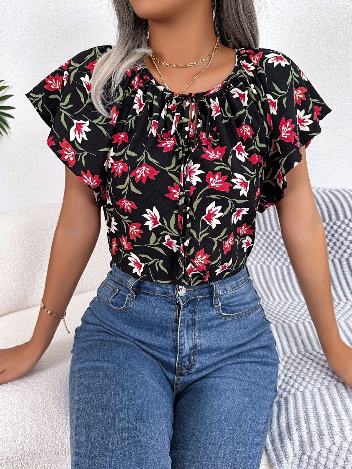 Black floral ruffle sleeve tie-neck blouse