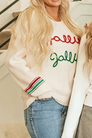 Ivory knit sweater with red "Jolly" and green "Jolly" embroidery and striped cuffs.
