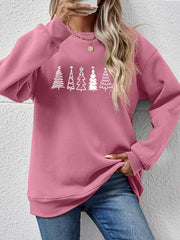 Blush pink oversized sweatshirt with a festive tree line graphic and crew neck.