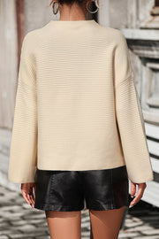 Tan ribbed mock neck sweater with volume sleeves and a relaxed fit.
