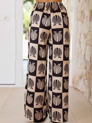 Black silk pajama pants with a shell print and checkered pattern.