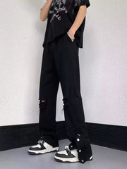 Black distressed loose-fit jeans with snap detail and adjustable hem