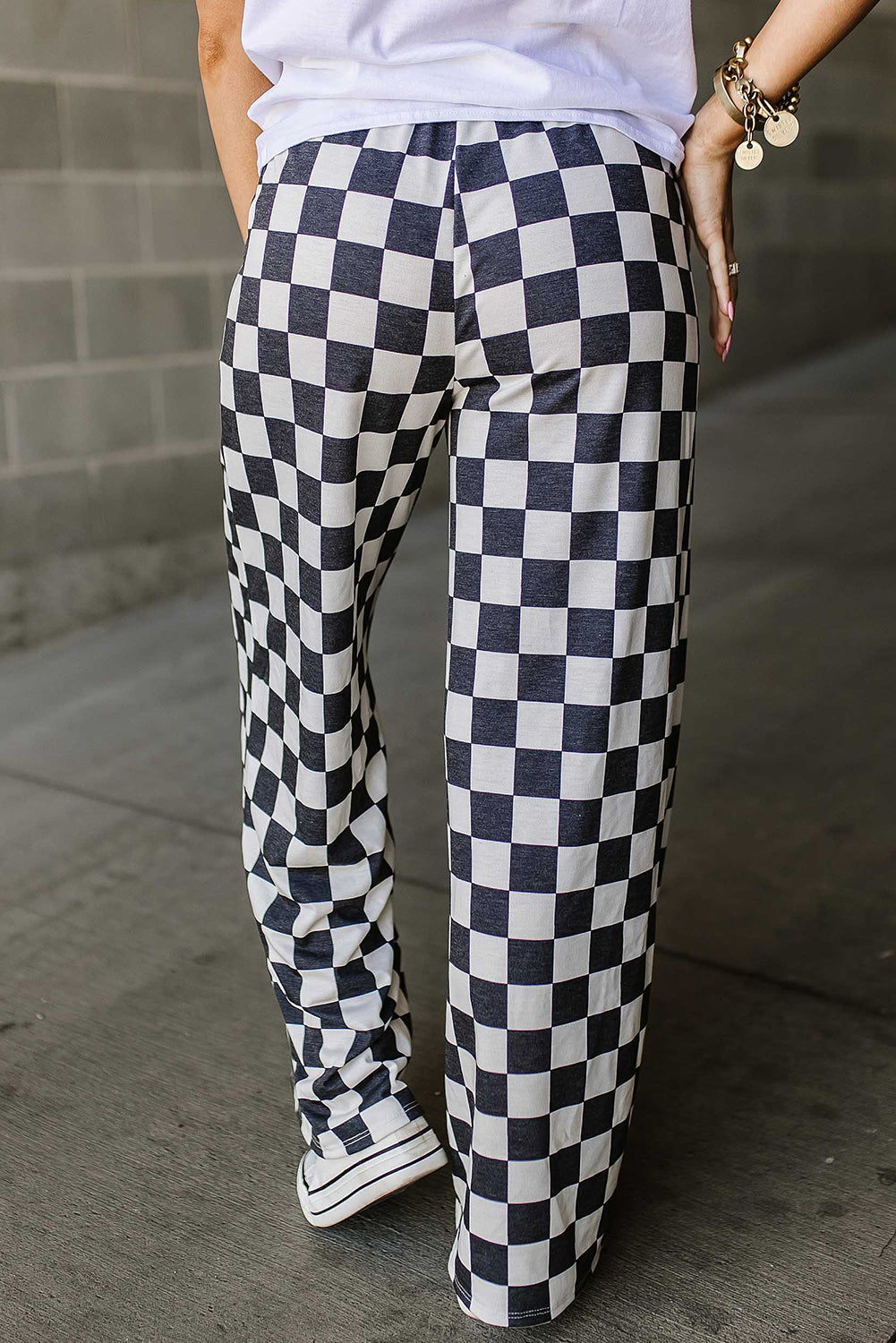 Checkerboard palazzo trousers in black and white, wide leg, casual fit.