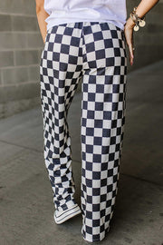 Checkerboard palazzo trousers in black and white, wide leg, casual fit.