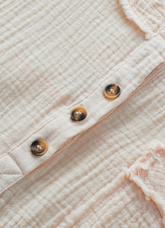 Beige textured gauze henley blouse with raw edges and button placket detail.