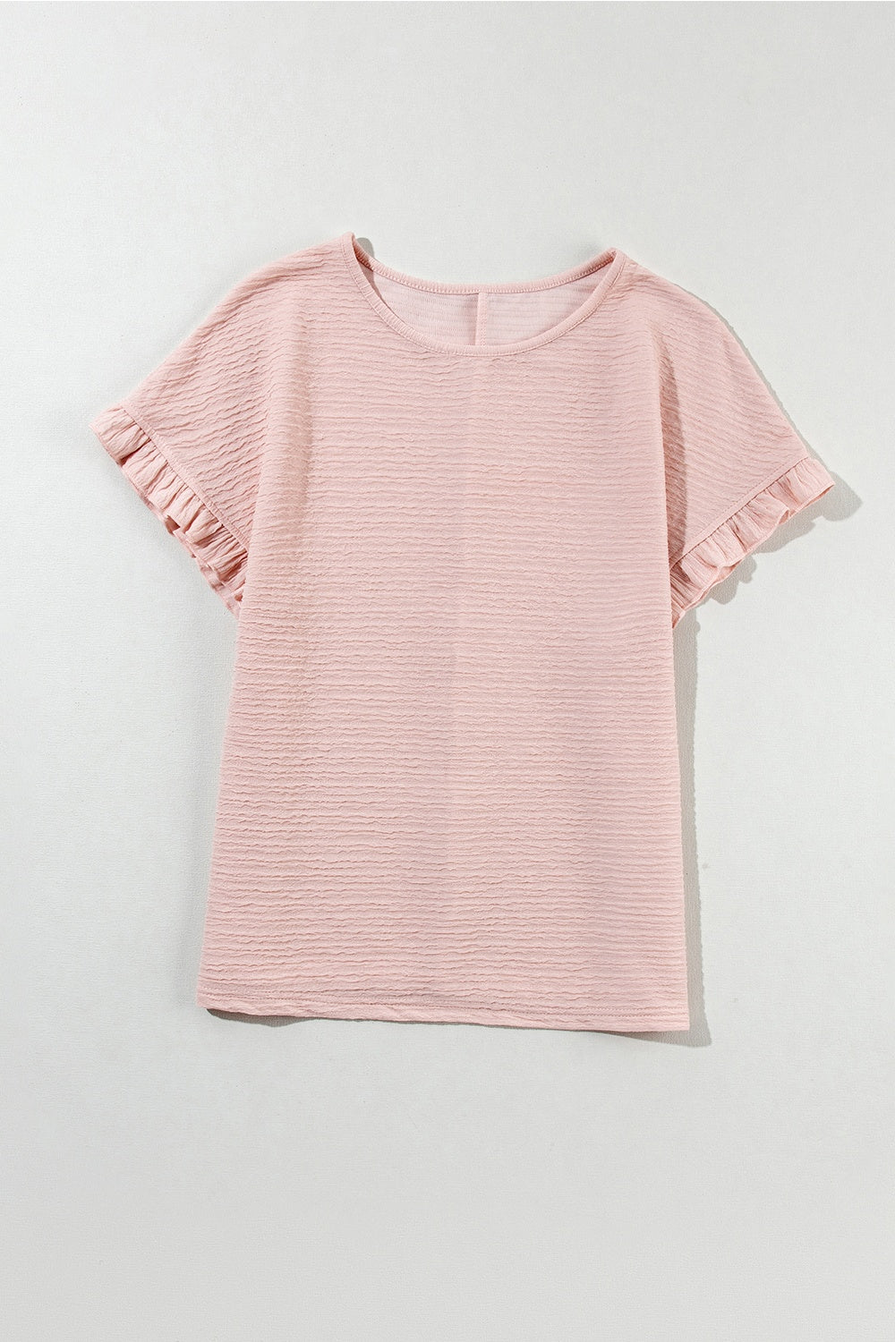 Blush pink textured top with short ruffle sleeves and a crew neck.