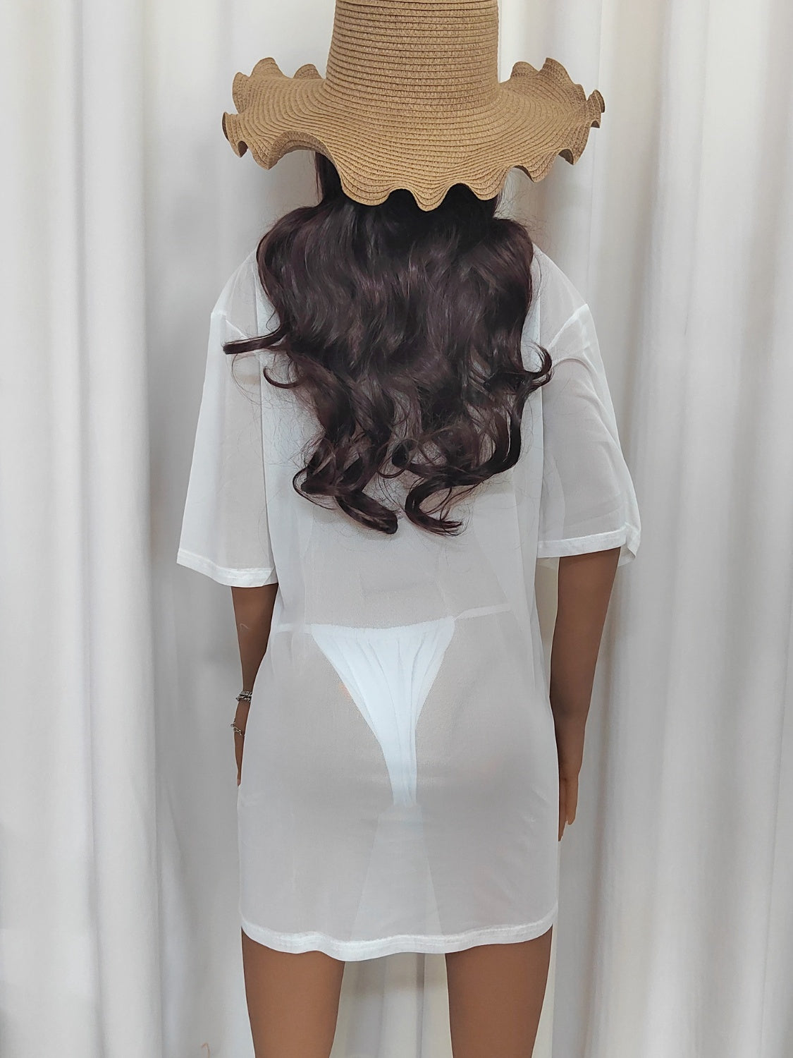White sheer mesh boatneck oversized top with short sleeves, styled with a straw hat.