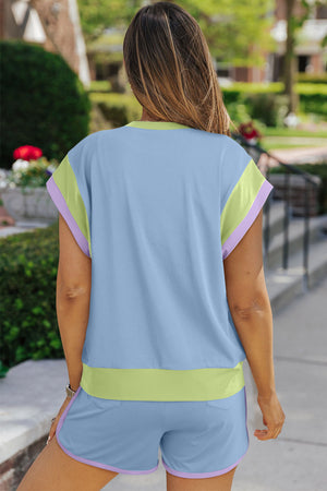 Light blue loungewear set with pastel trim details on sleeves and shorts.