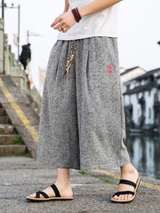Gray relaxed fit wide-leg casual pants with drawstring and red embroidered detail.