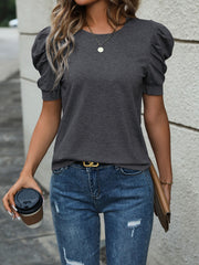 Dark gray jersey top with puffed short sleeves and a round neckline.