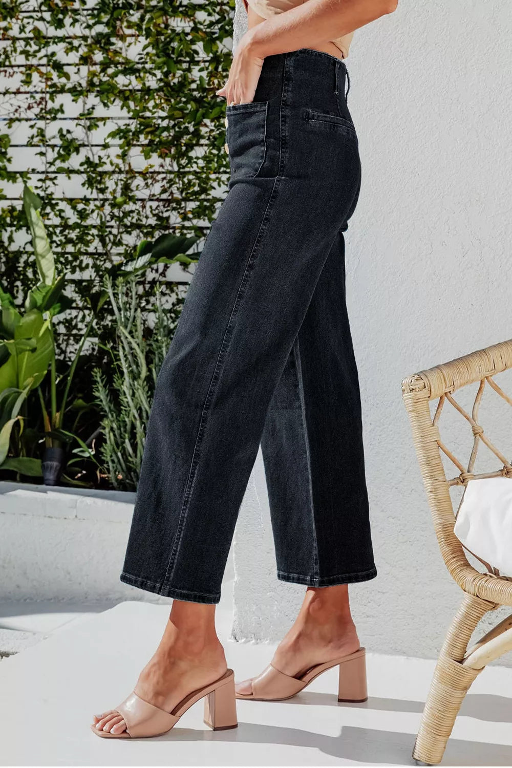 Black denim wide-leg jeans with button-fly detail and cropped length.
