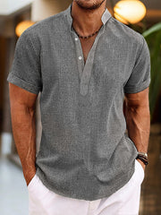 Men's gray short sleeve cotton blend henley shirt with buttoned placket.