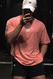 Logo Detail Oversized Tee in Burnt Coral with a white chest logo and short sleeves.