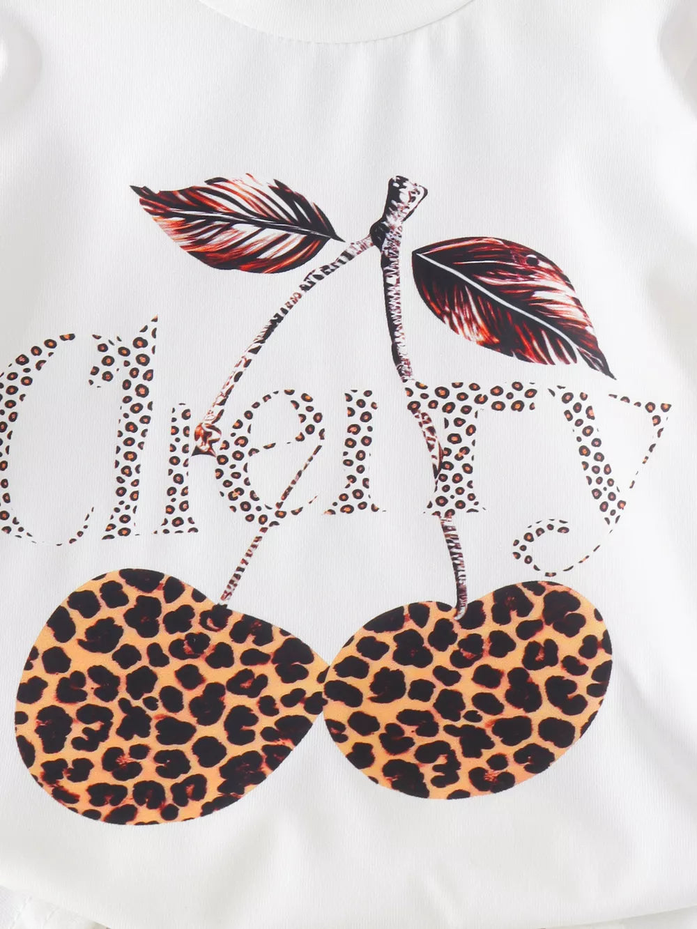 Children's Cherry Leopard Tee And Flare Pants Set in White, close-up detail