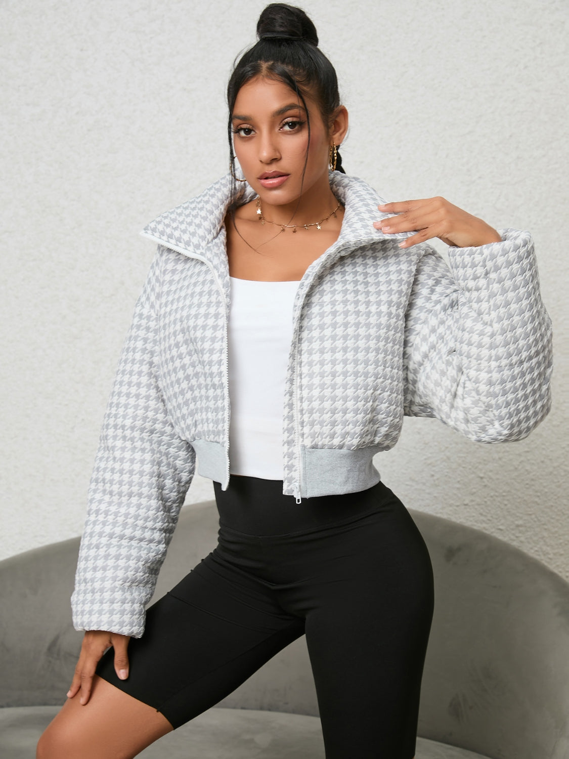 White houndstooth cropped jacket with padded collar and zipper.