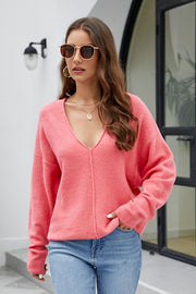 Watermelon pink textured knit pullover with deep V-neck and seam detail.
