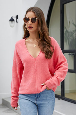 Watermelon pink textured knit pullover with deep V-neck and seam detail.
