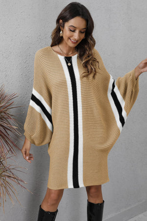 Oversized knit cocoon dress in khaki with black and white stripe details on the front and sleeves.