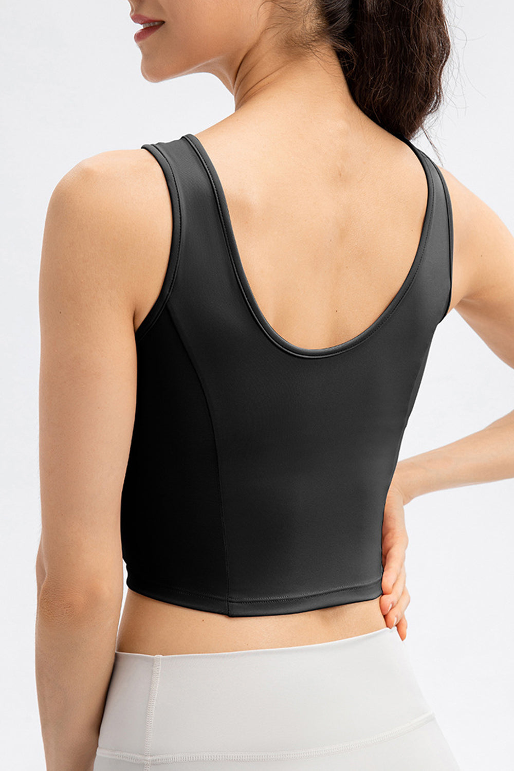 Black active crop top with sculpted seams and a U-neck.