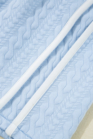 Light blue loungewear set with cable knit texture and white trim detail.