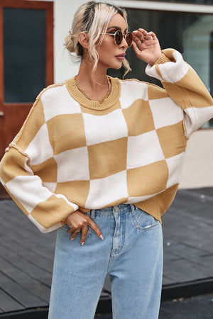 Checkerboard knit relaxed crewneck sweater in tan and white acrylic with balloon sleeves.