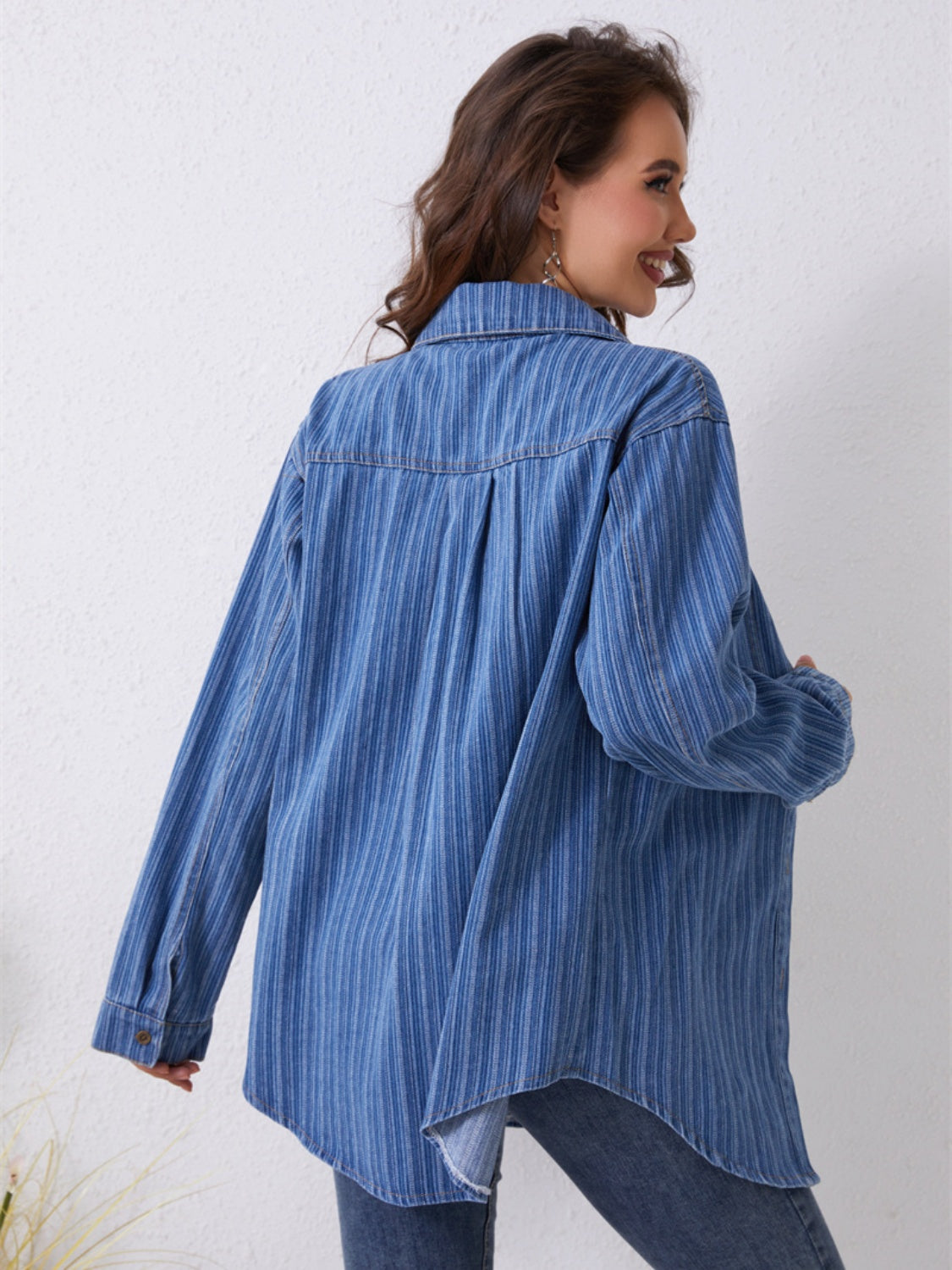 Medium denim overshirt with vertical stripes and pockets, shown from the back.