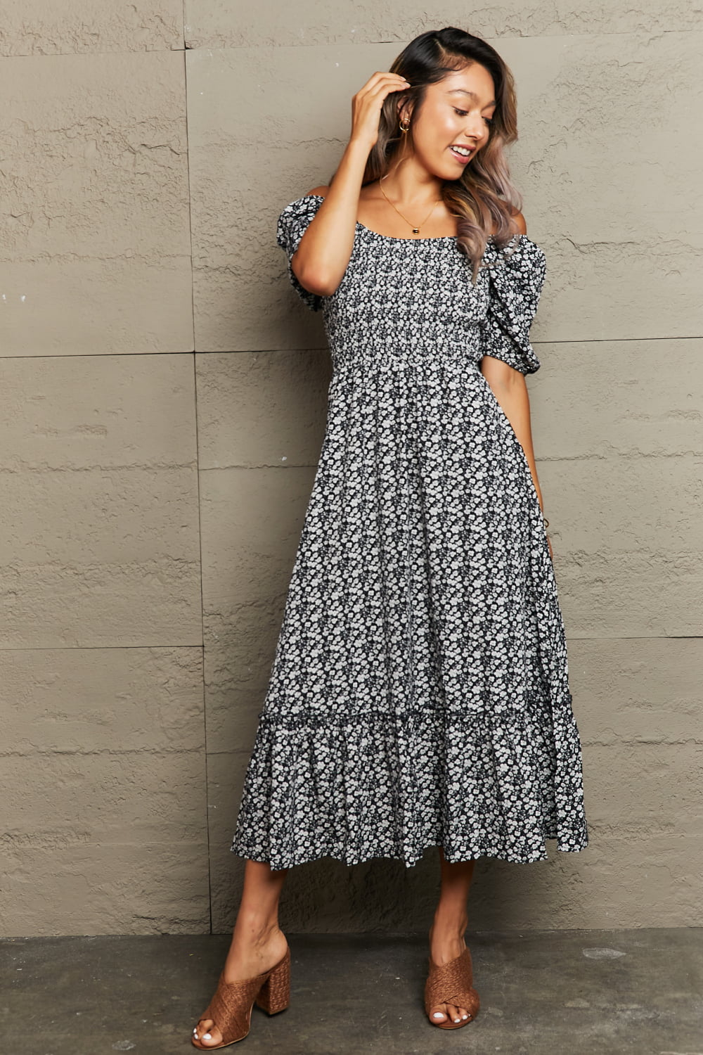 Black floral print midi dress with smocked bodice and puff sleeves.