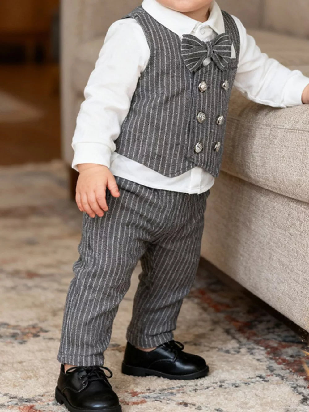 Baby boy's dark gray pinstripe vest and pants set with white shirt and bow tie.
