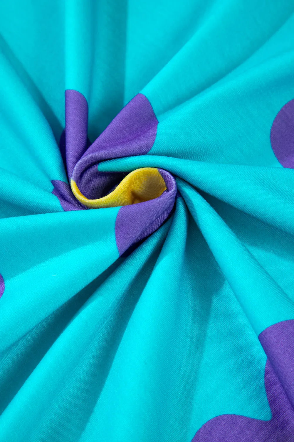 Daisy print crewneck top in pastel blue with purple and yellow accents.
