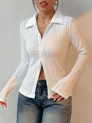 White textured shirred blouse with a collared neckline and button-up front, featuring a sculpted silhouette.