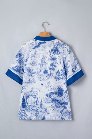 White polyester shirt with blue toile print, V-neck, short sleeves, and blue trim.