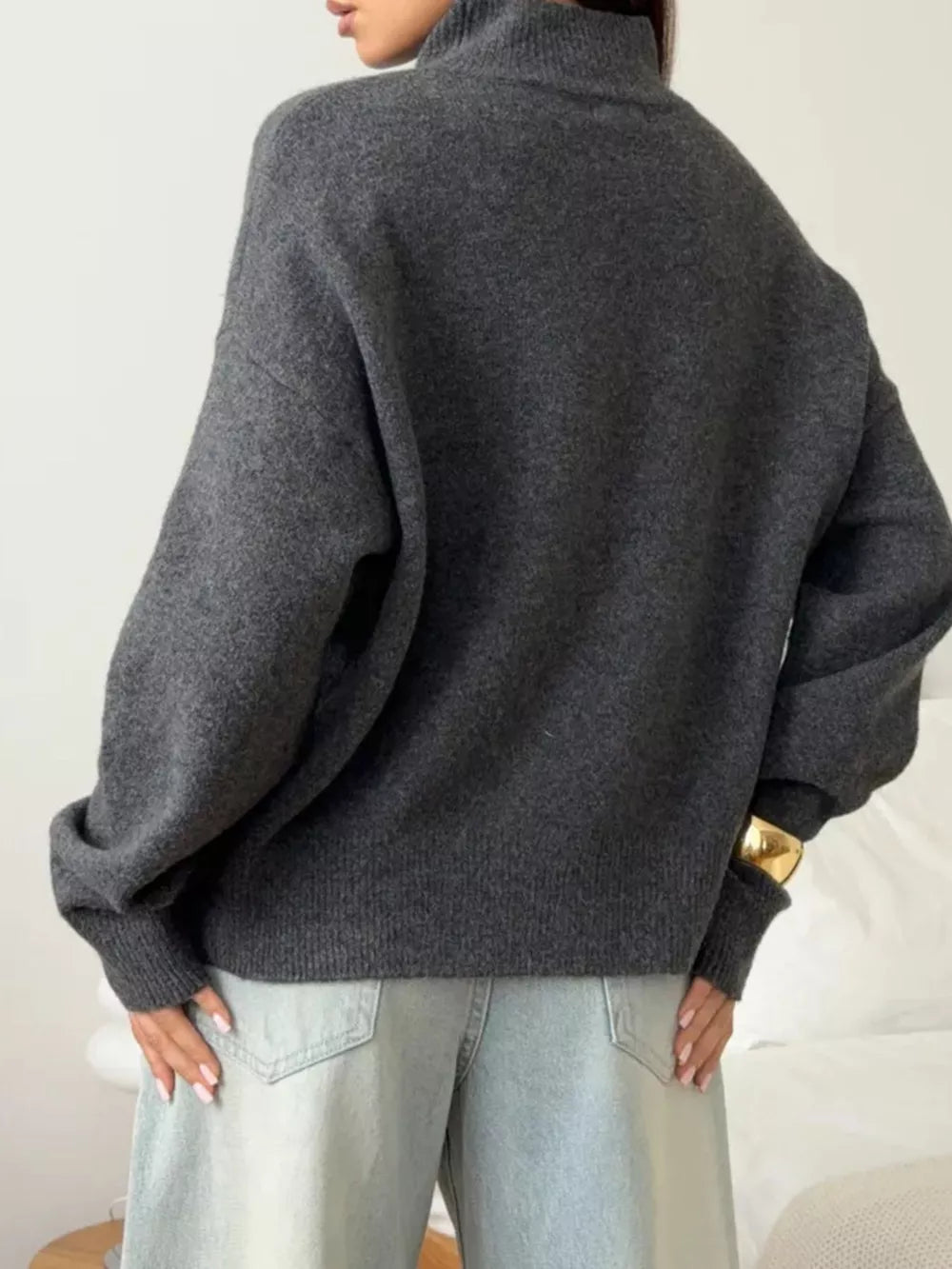 Relaxed mock neck sweater in dark gray acrylic blend with dropped shoulders and cuffed sleeves.