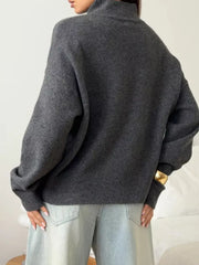 Relaxed mock neck sweater in dark gray acrylic blend with dropped shoulders and cuffed sleeves.