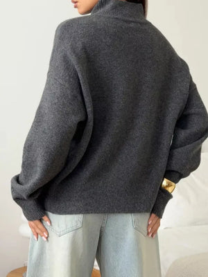 Relaxed mock neck sweater in dark gray acrylic blend with dropped shoulders and cuffed sleeves.