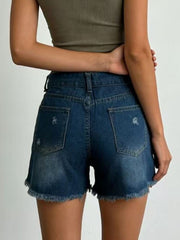 Dark blue denim shorts with frayed hem and distressed details.