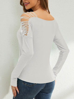 White ribbed knit blouse with strappy cold shoulder detail and embellished accents.