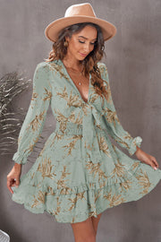 Tie-front prairie floral mini dress in Gum Leaf with smocked waist and ruffled hem.