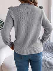 Gray textured knit sweater with ruffle yoke detail and mock neck.