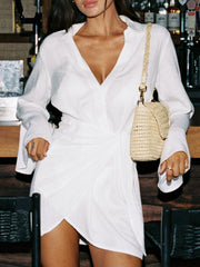 Chic white cotton blend cover-up dress with V-neck, long sleeves, and twisted detail.