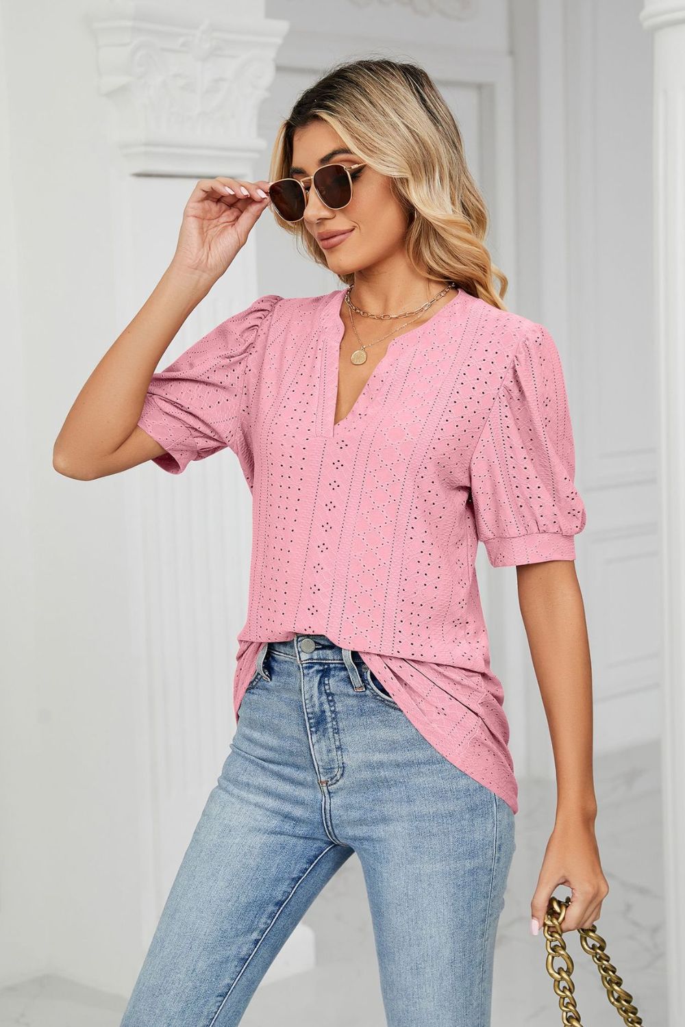 Pink perforated puff sleeve blouse with keyhole neckline and eyelet details.
