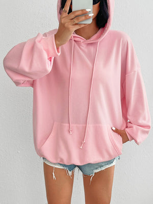 Oversized blush pink hoodie with drawstring detail and front pocket.