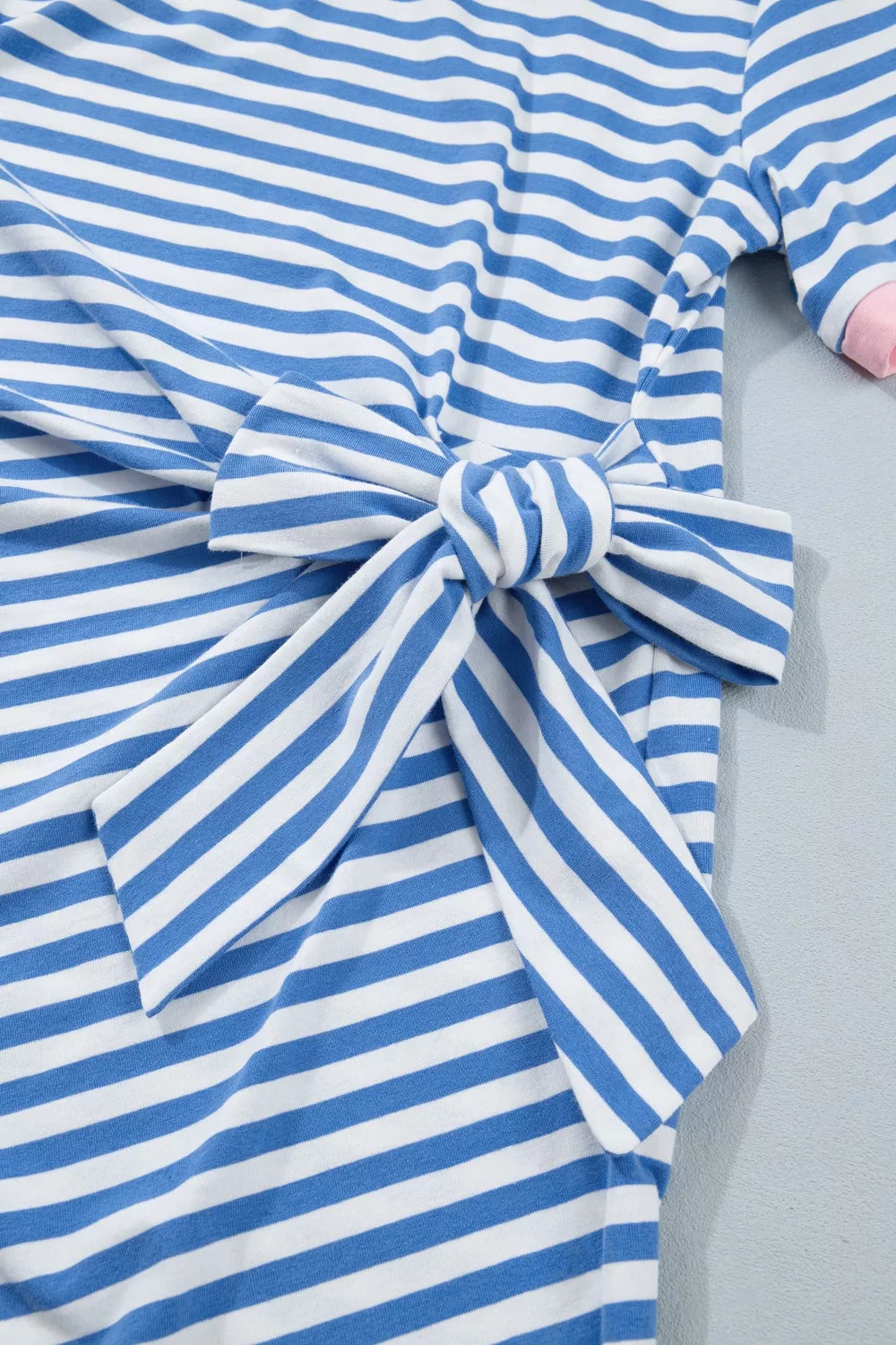 Blue and white striped cotton mini dress with a tie detail at the waist.