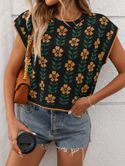 Black knit sleeveless top with yellow floral print and green leaves.