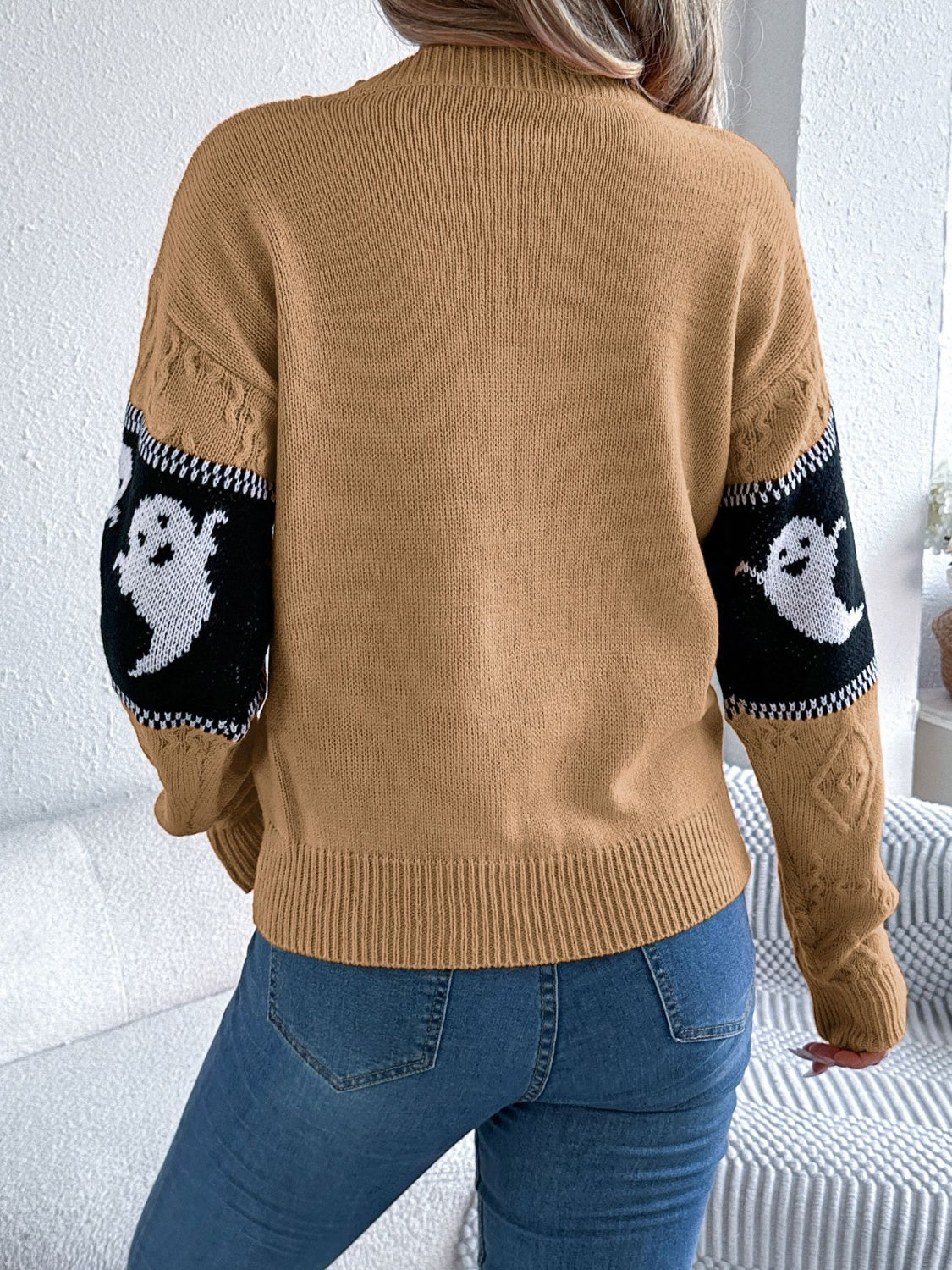Camel knit crewneck sweater with ghost motif on sleeves, cable knit details