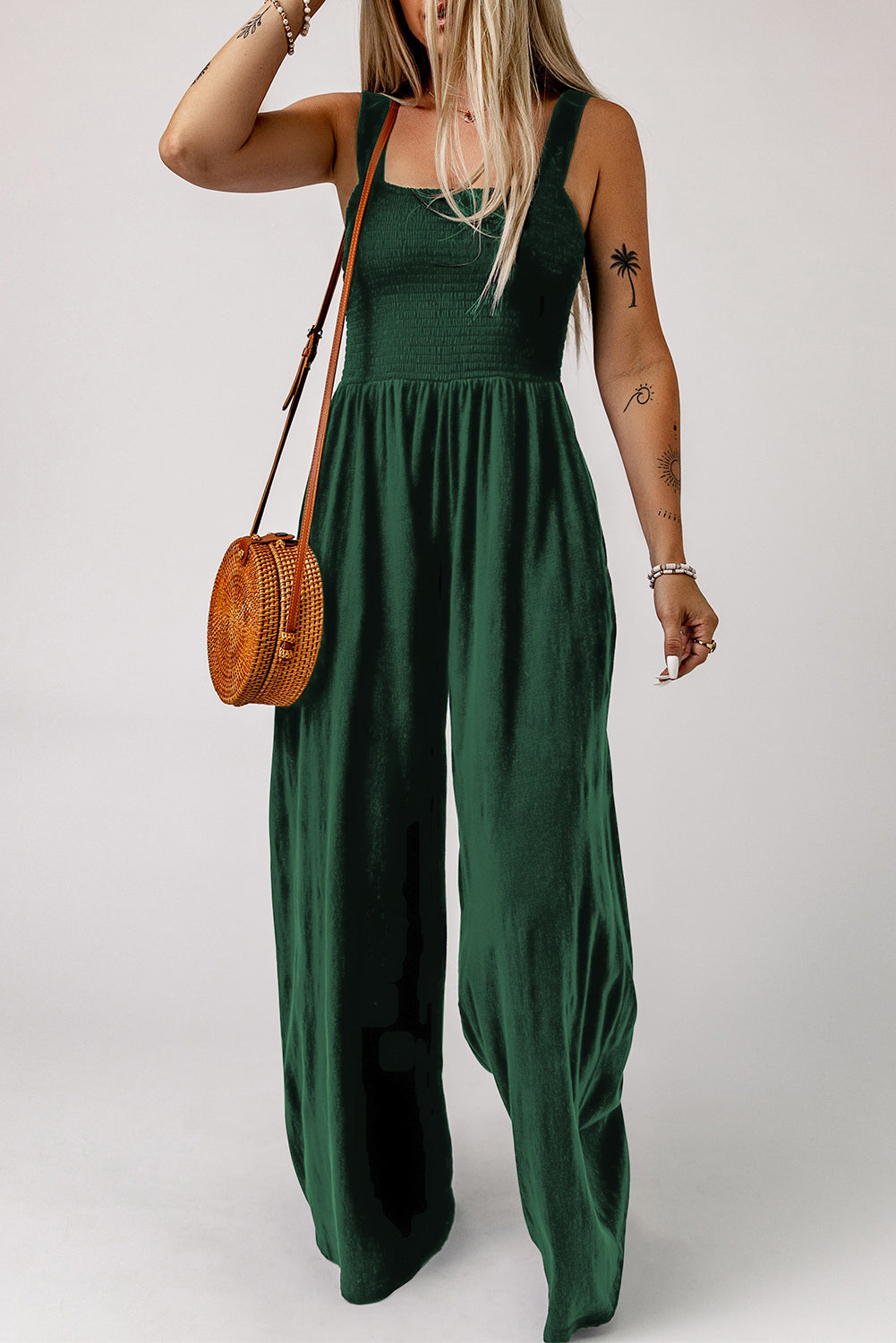Green smocked square neck wide leg jumpsuit with spaghetti straps.
